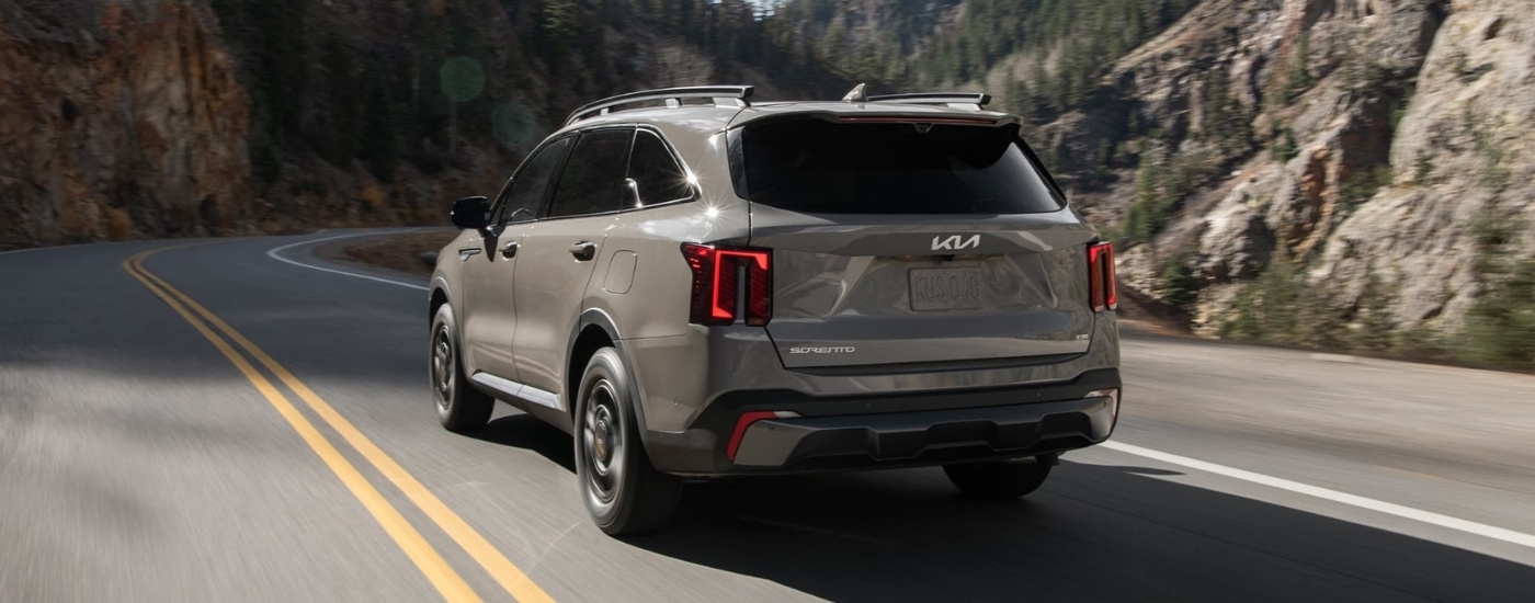 A grey 2024 Kia Sorento driving on a highway.