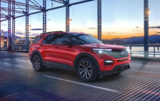 New 2023 Ford SUV driving over bridge during sunset