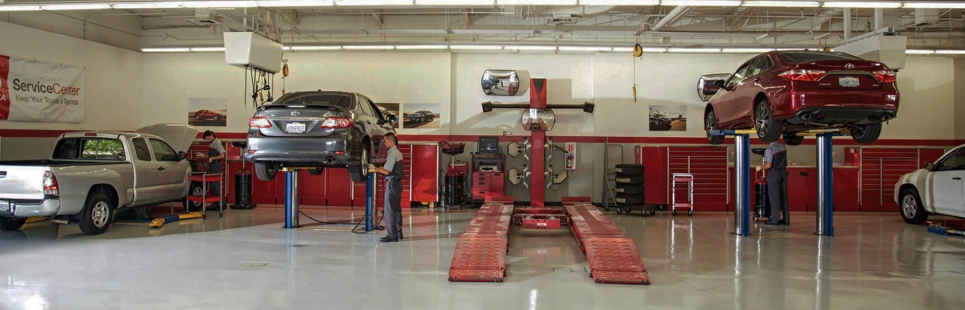 Toyota of Dartmouth Service Center- Technicians servicing Toyota vehicles on car lift