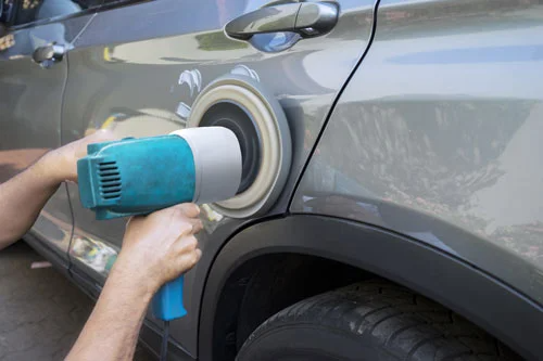 Car Detailing Service - service tech polishing car paint