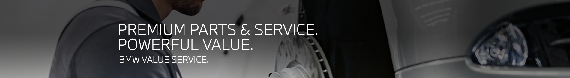 BMW Service Technician performing a brake disc change on a BMW vehicle on a lift in a BMW Service Center.