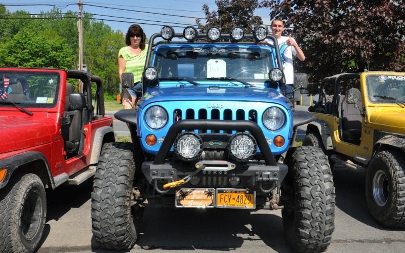 A blue Jeep Wrangler from the front.