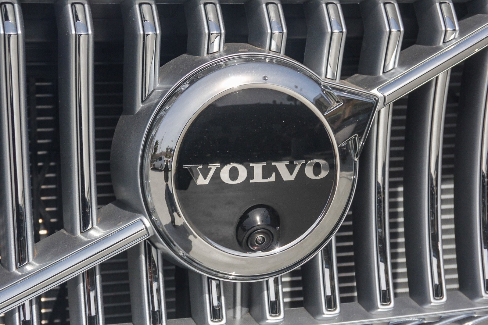 camera on the front of a white 2025 Volvo XC90 SUV parked at the Volvo Cars Mission Viejo dealership