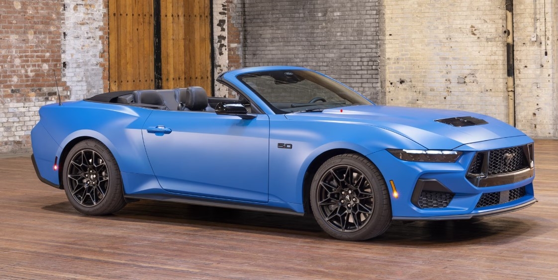 blue 2025 ford mustang convertible parked on the road