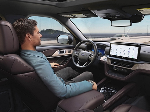 person using Ford BlueCruise hands-free driving tech on a road in Albuquerque, NM