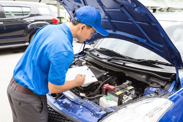 Mechanic checking under a car hood