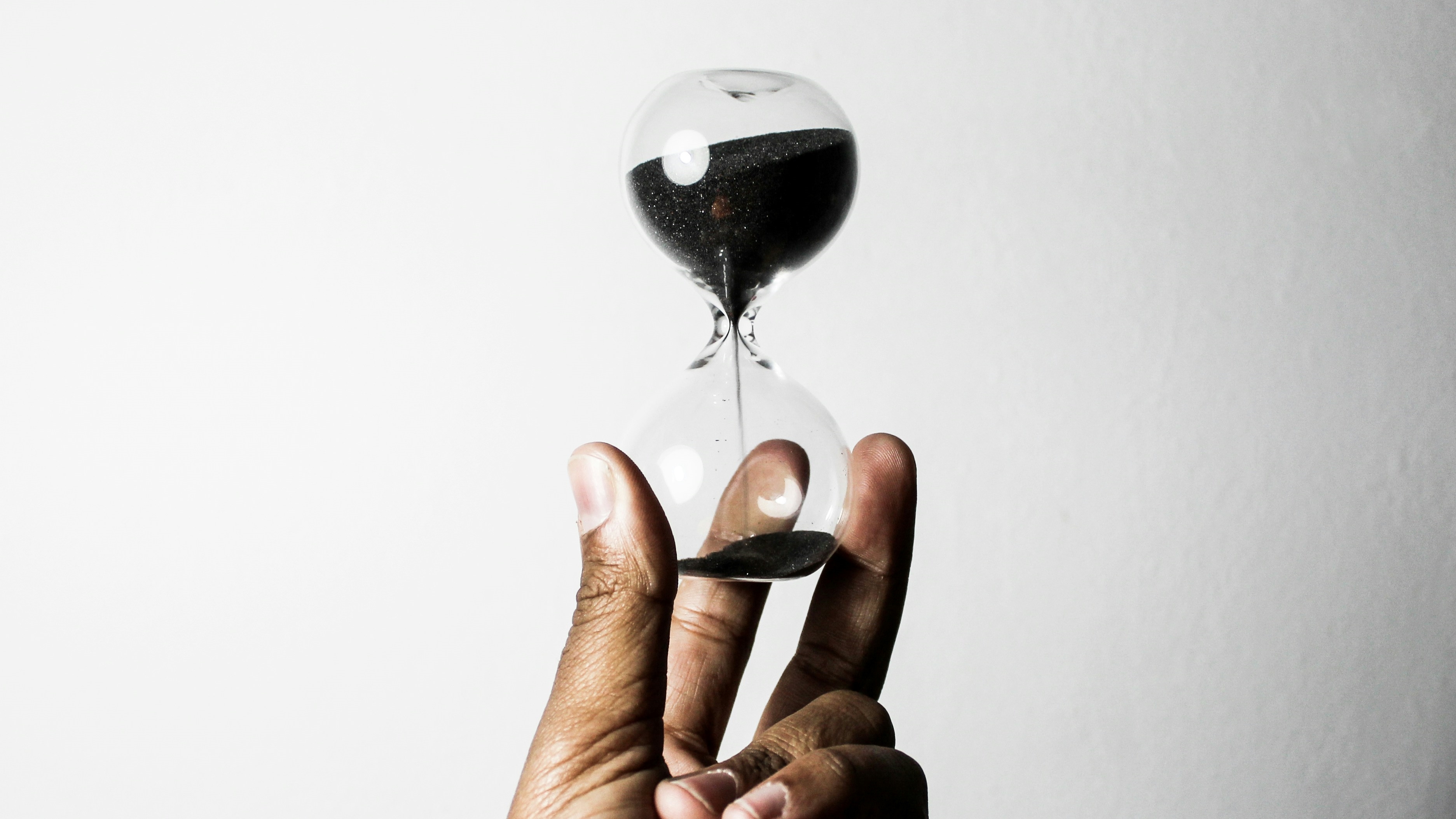 Hand holding an hourglass
