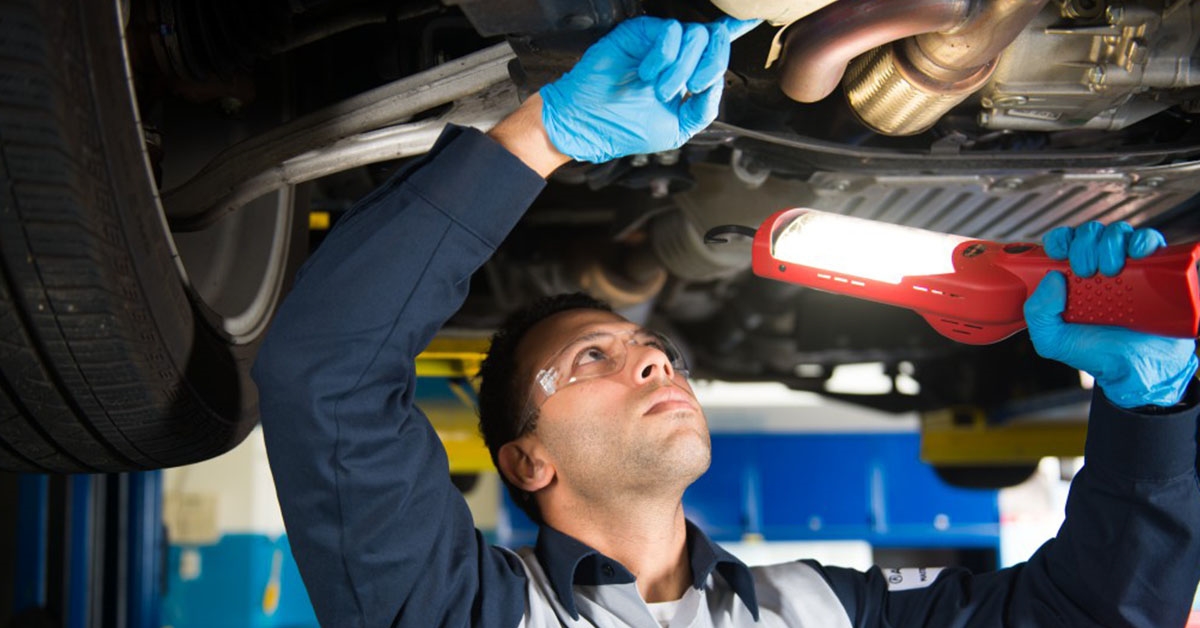 Acura service technician under the car