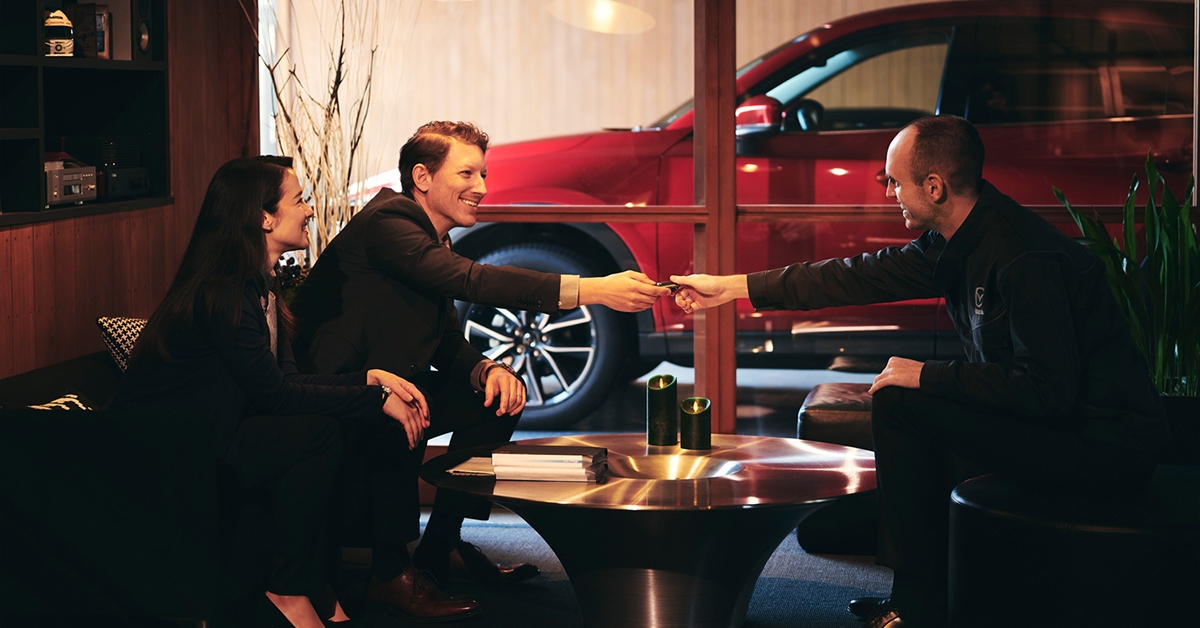 Handing over key at the Mazda dealership