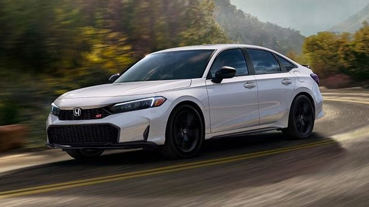 2026 Honda Civic Si sedan in white cornering on a mountain road