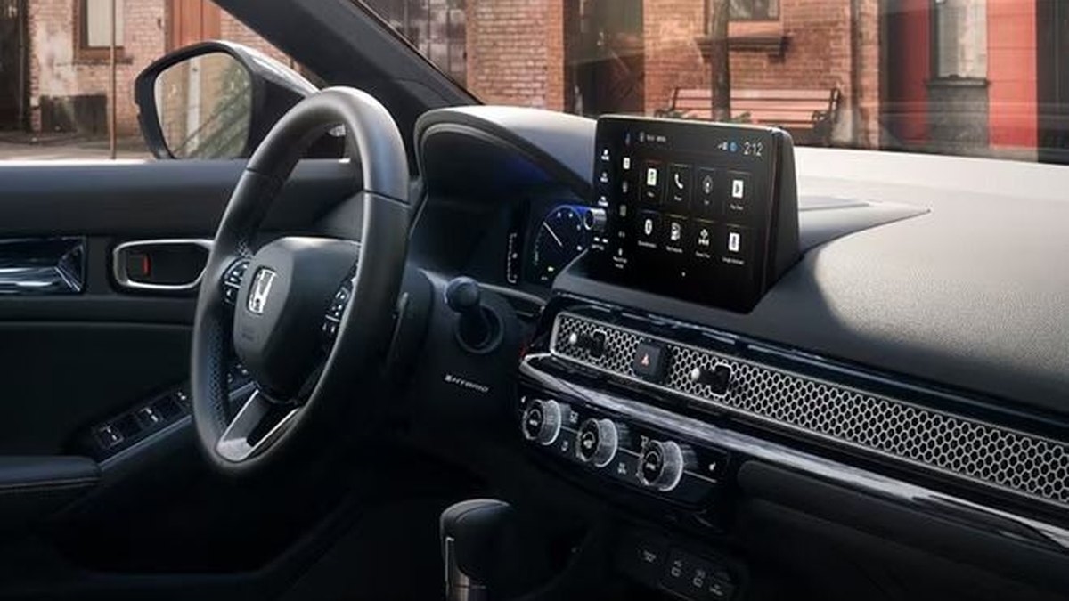 2026 Honda Civic Sport Touring Hybrid dashboard with 9-inch touchscreen and metal honeycomb trim