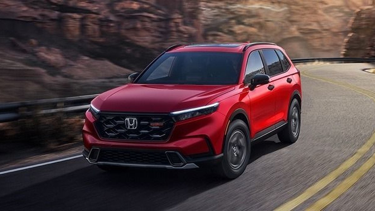 2026 Honda CR-V TrailSport Hybrid in Radiant Red Metallic on a canyon road