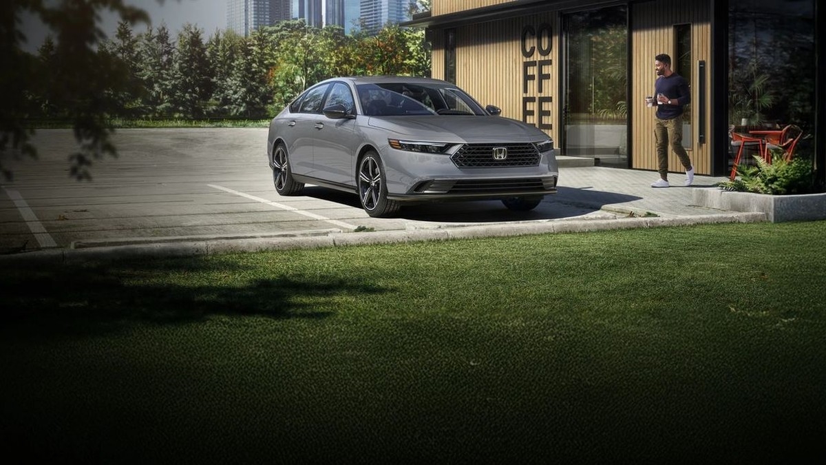2026 Honda Accord sedan in silver parked outside a coffee shop