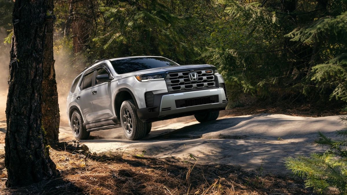 2026 Honda Pilot TrailSport in Solar Silver Metallic on a dirt trail through the woods