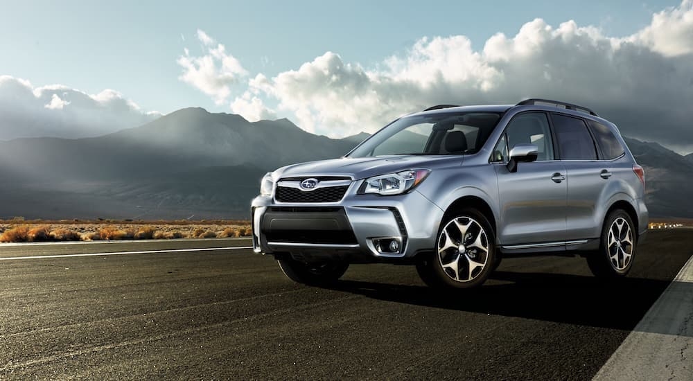 A silver 2015 Subaru Forester is shown on pavement after leaving a Subaru dealer near you.