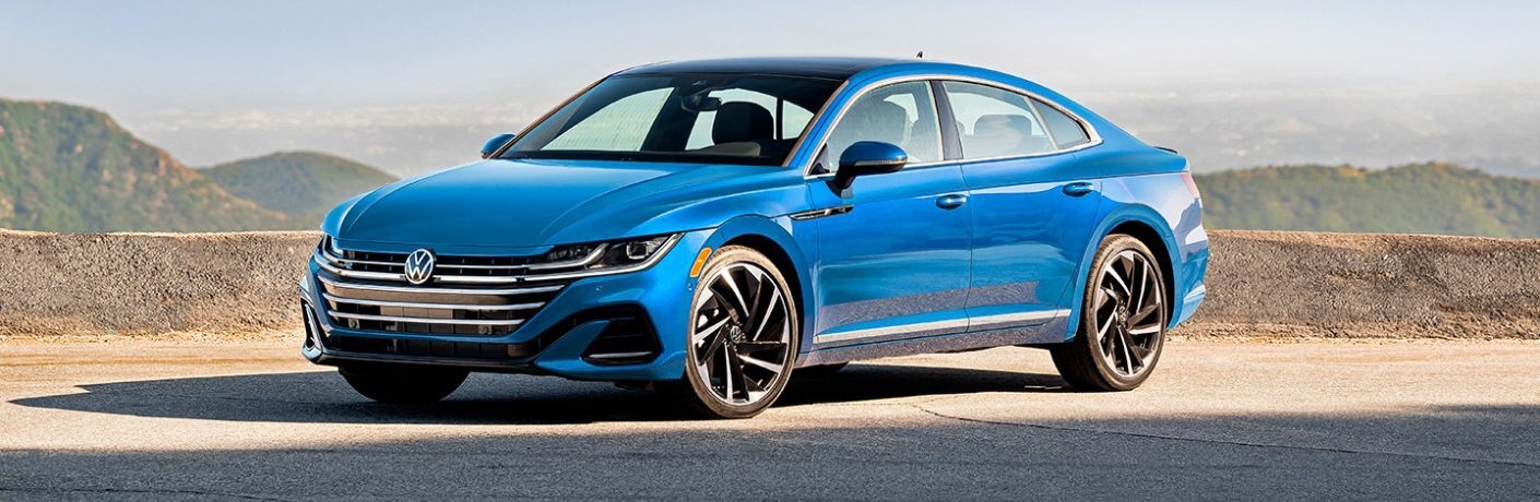 Blue 2023 Volkswagen Arteon Front Exterior on a Desert Highway