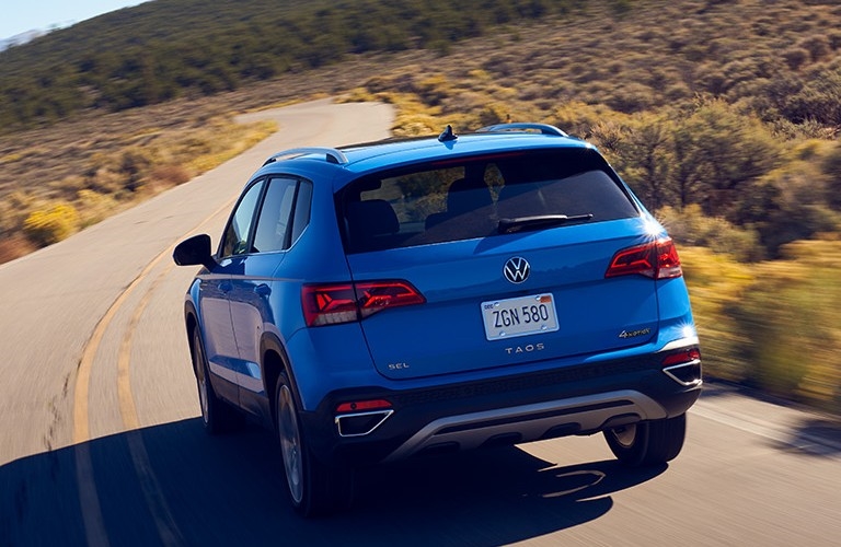 rear view of 2023 VW Taos driving on highway