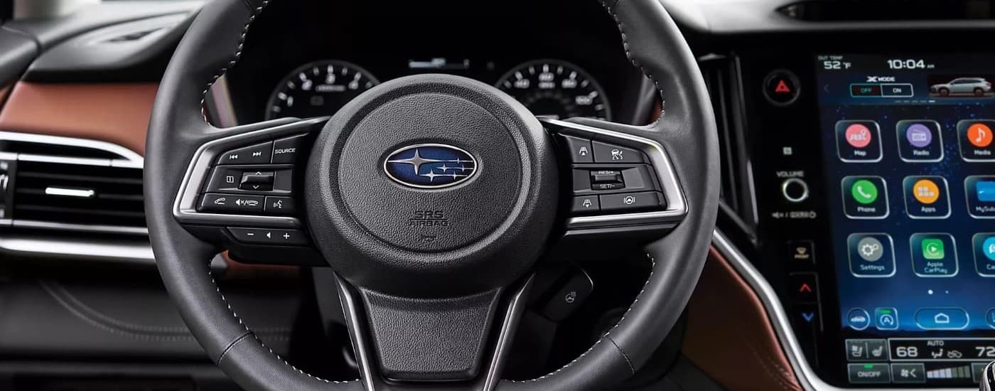A close up shows the steering wheel of a 2021 Subaru Outback for sale.
