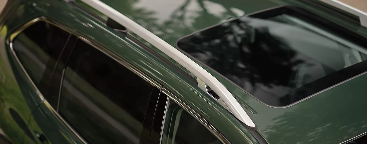 A close up of the roof and sunroof on a green 2023 Subaru Forester is shown.