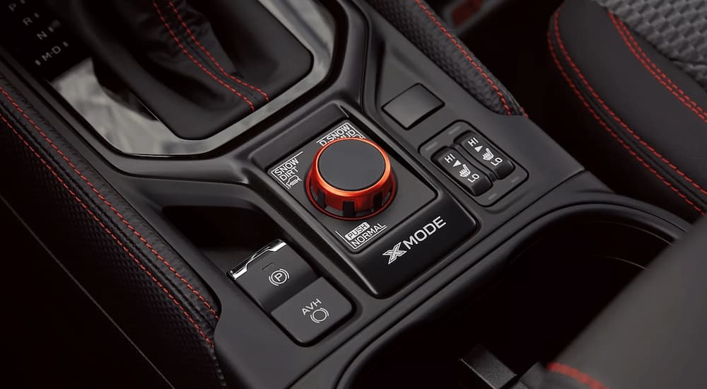 A close up of the shifter and X-Mode knob in a 2023 Subaru Forester for sale is shown.