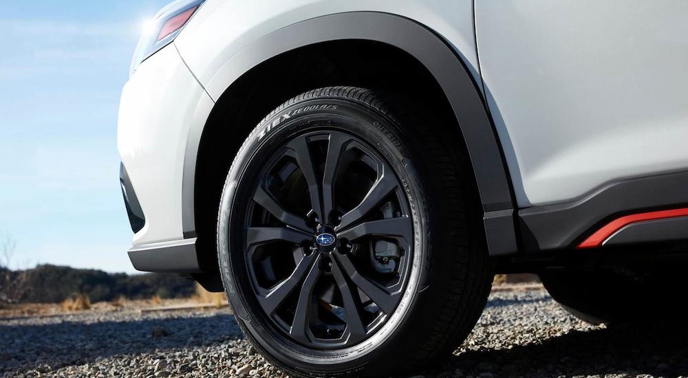 A close up of the tire and rim on a white 2023 Subaru Forester Sport for sale is shown.