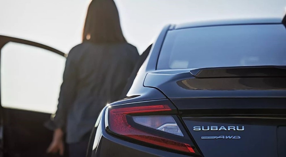 A person is shown exiting a black 2023 Subaru WRX for sale.