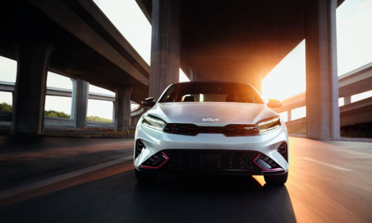 2023 Kia Forte driving head on in sun