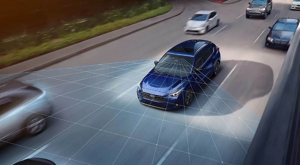Simulated EyeSight sensors are shown coming from a blue 2024 Subaru Impreza for sale.