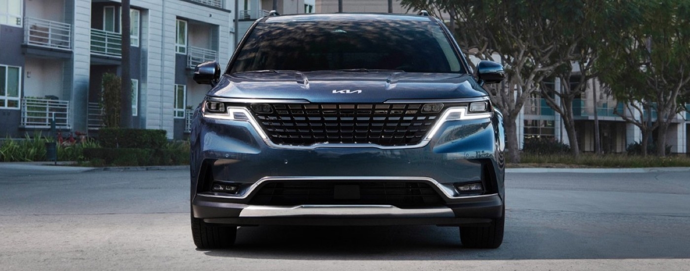 A blue 2023 Kia Carnival is shown from the front parked after visiting a Kia dealership near Port Lavaca.