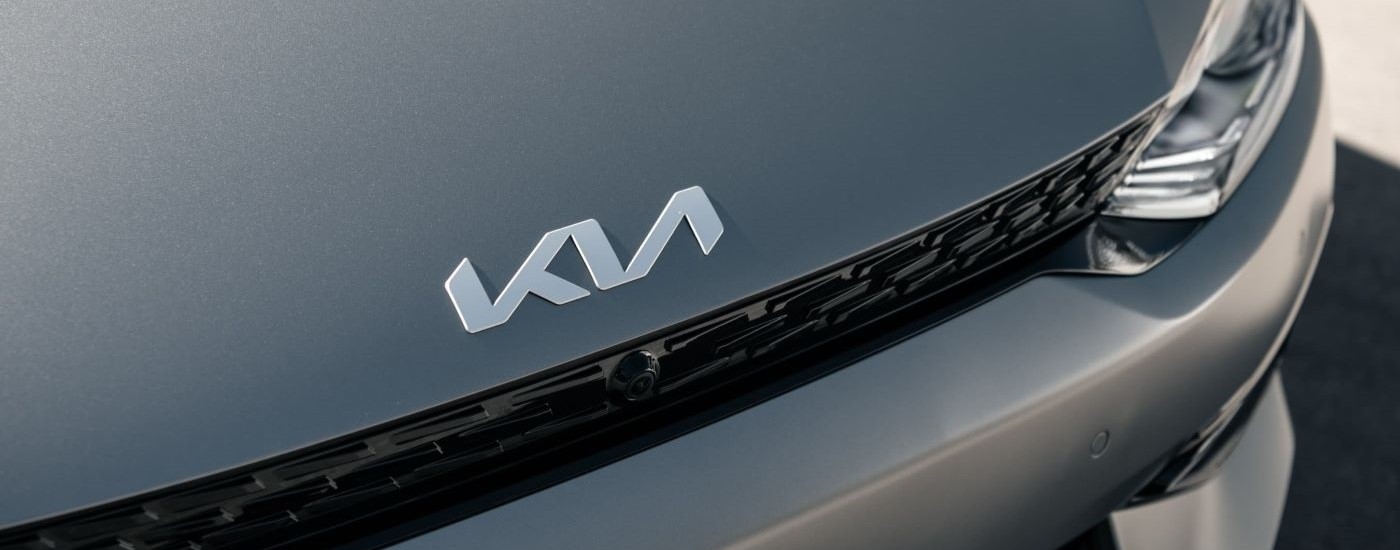The Kia logo and grille on a silver 2022 Kia EV6 is shown at a Kia dealer near Corpus Christi.
