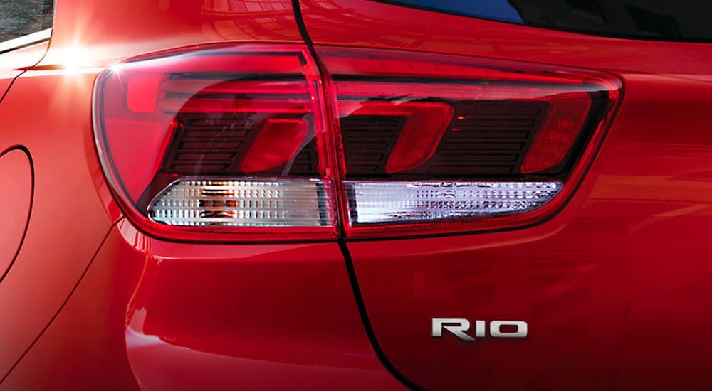 A close up of the driver side taillight on a red 2023 Kia Rio.
