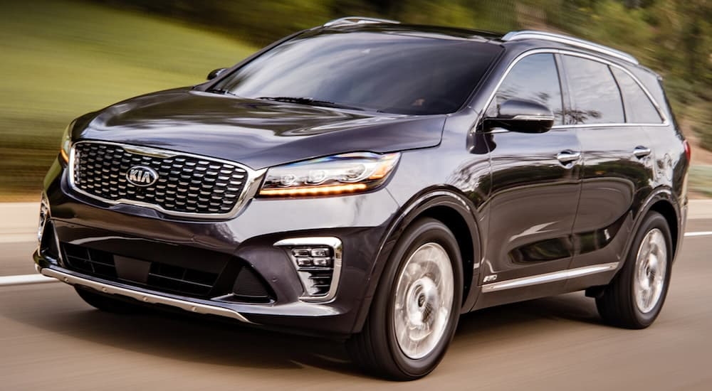 Front view of a black 2020 Kia Sorento driving on an open road.