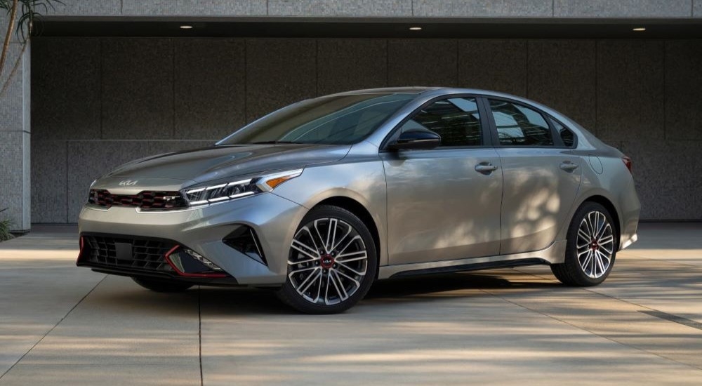 A silver 2023 Kia Forte GT is parked on a driveway.