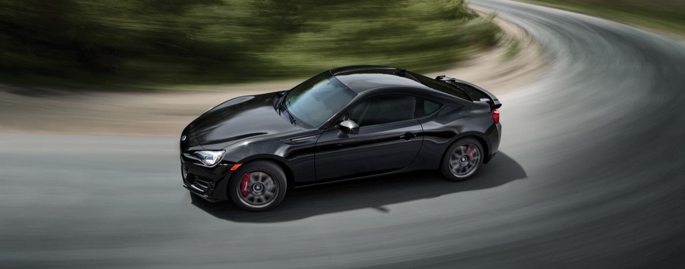 A black 2019 Subaru BRZ is shown rounding a corner after leacing a car dealer ear Poughkeepsie.