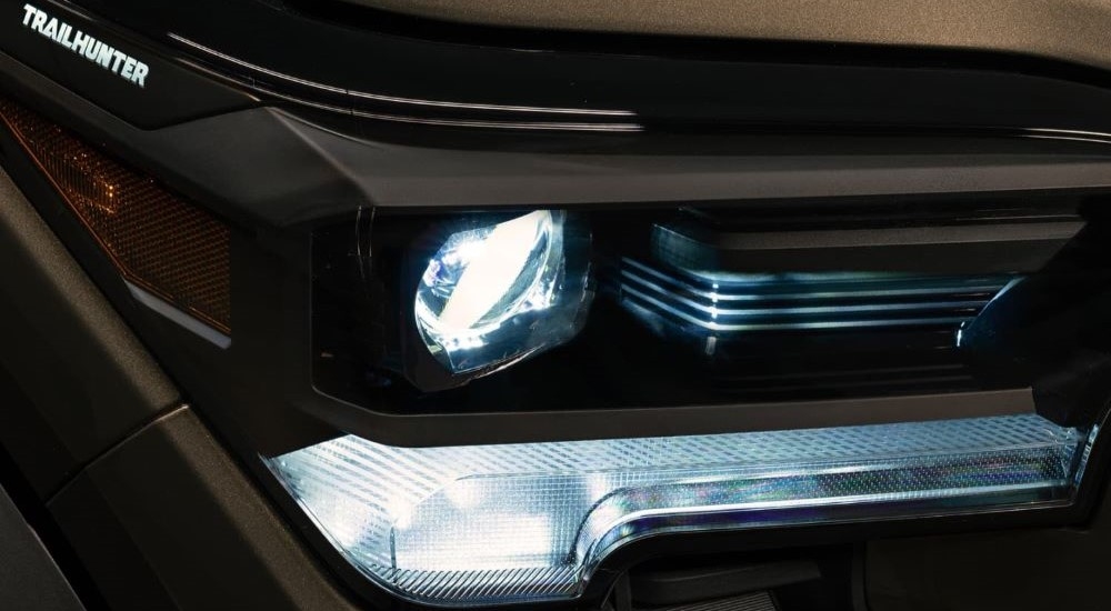 A close up shows the headlight on a green 2024 Toyota Tacoma Trailhunter.