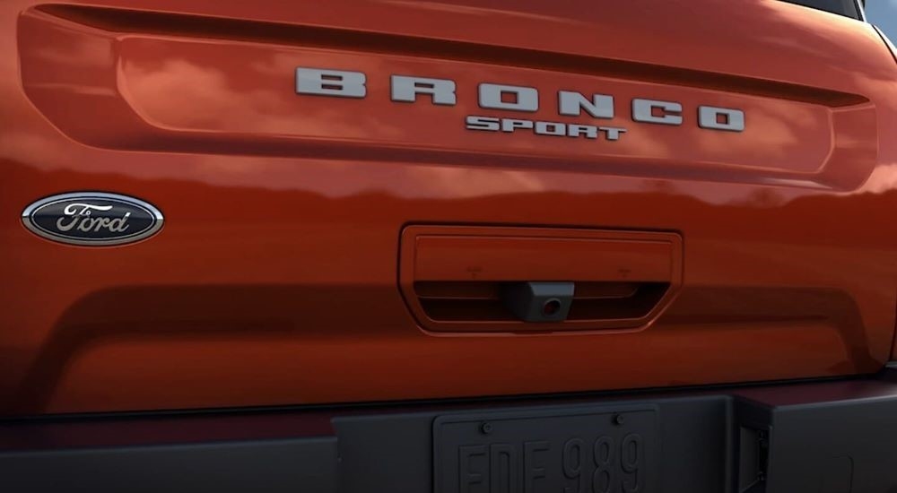 A close up shows the badging on the trunk of an orange 2023 Ford Bronco Sport Badlands.