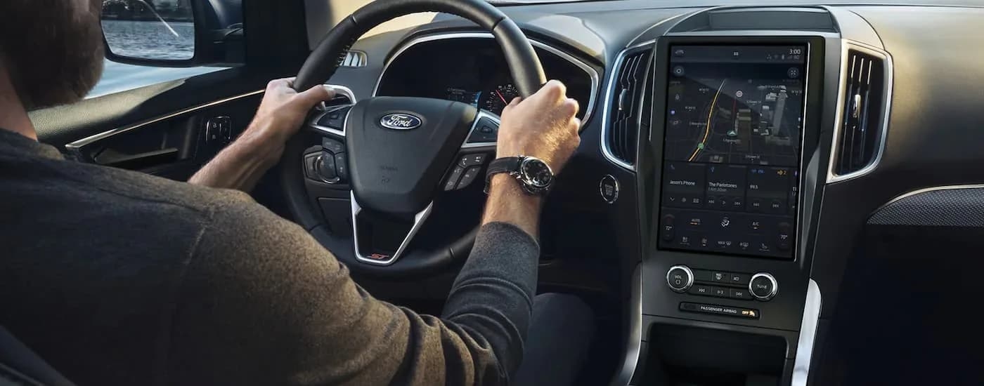A man is shown driving a 2022 Ford Edge ST to a Ford dealer.