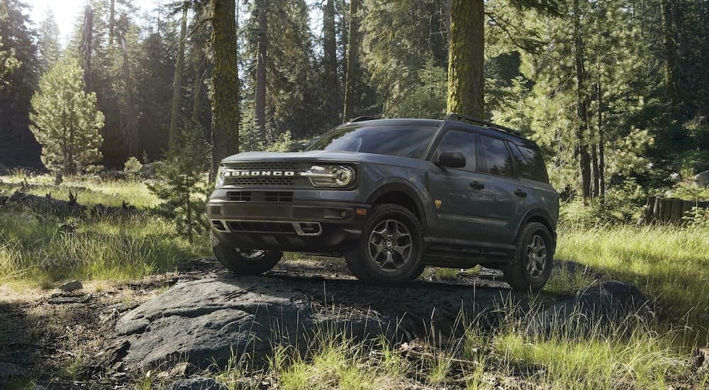 A black 2022 Ford Bronco Sport Badlands is shown parked on a rock in the woods.