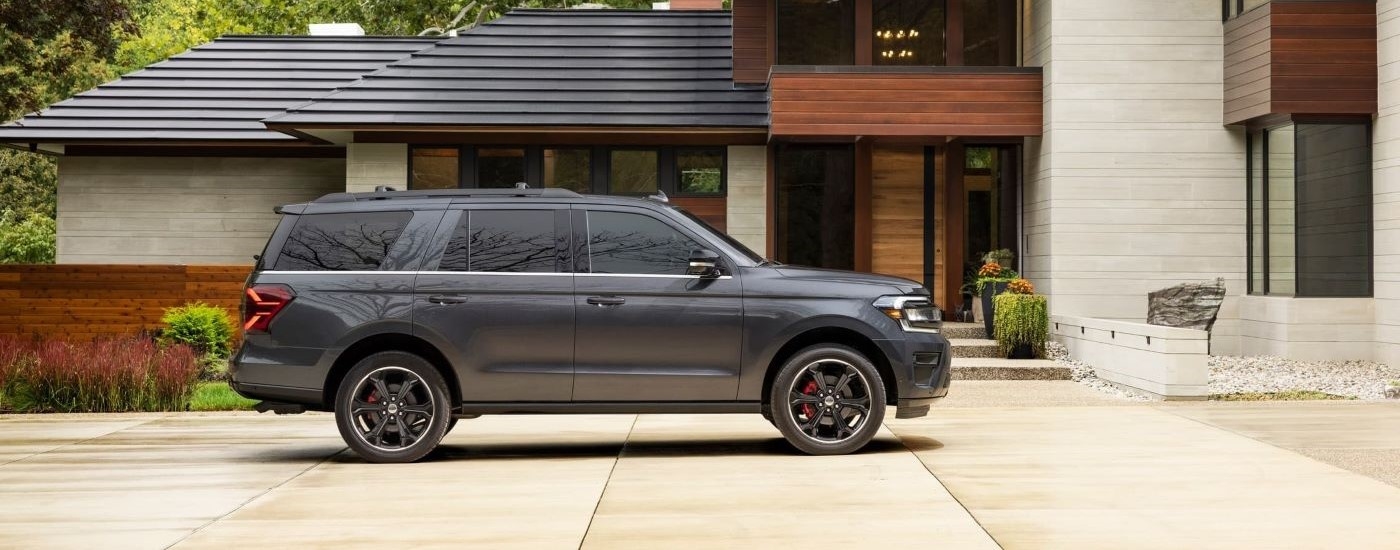 A grey 2022 Ford Expedition Stealth Edition is shown from the side parked in a driveway.