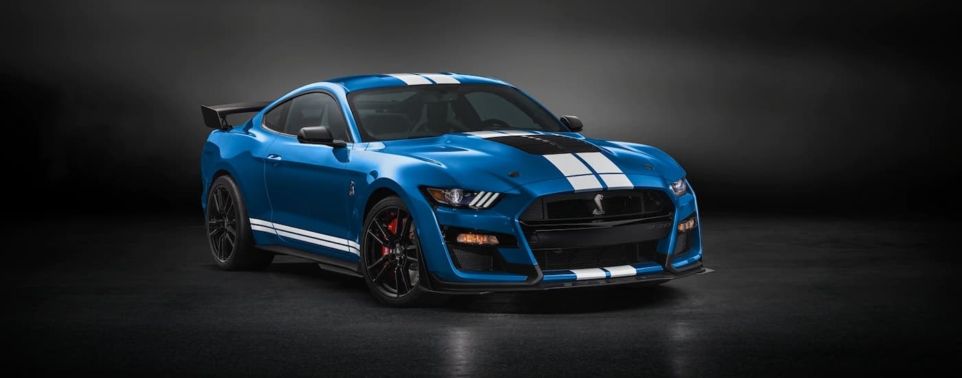 A blue 2022 Ford Mustang Shelby GT500 is shown against a dark background.