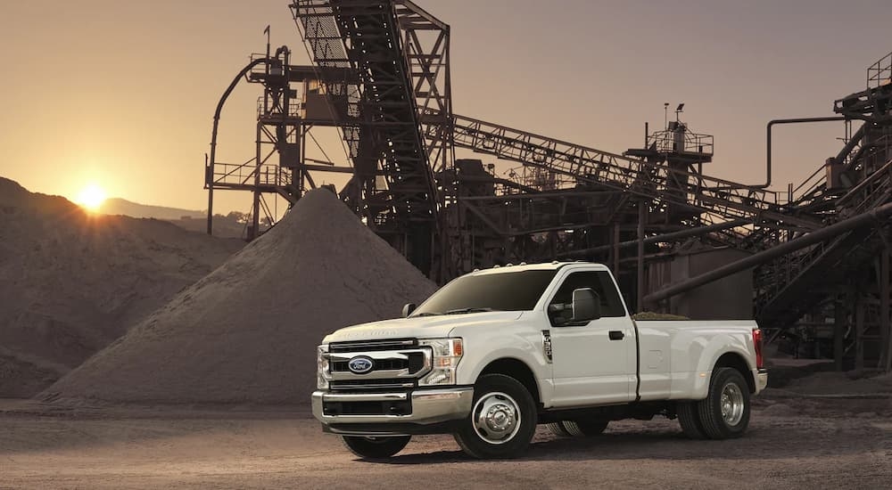 A white 2022 Ford F-350 Super Duty is shown at a construction site.