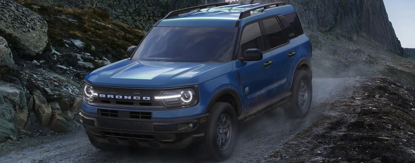 A blue 2022 Ford Bronco Sport Big Bend is shown descending a dirt trail.