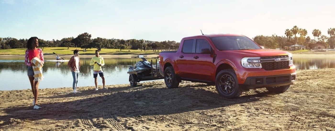 A red 2022 Ford Maverick is shown at a lake after leaving a New Paltz Ford dealer.