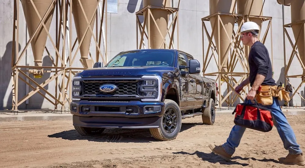 A black 2023 Ford F-250 is shown from the front at an angle after leaving a dealer that has a Ford F-250 for sale.