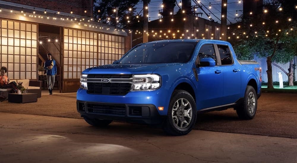 A blue 2022 Ford Maverick is shown parked at night.