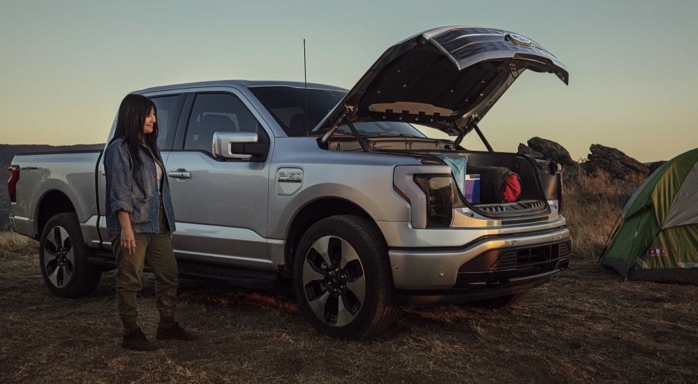 A silver 2022 Ford F-150 Lightning is shown with the front storage open after leaving a Rhinebeck Ford dealer.
