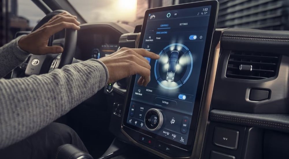 The black interior of a 2022 Ford F-150 Lightning shows the infotainment screen.