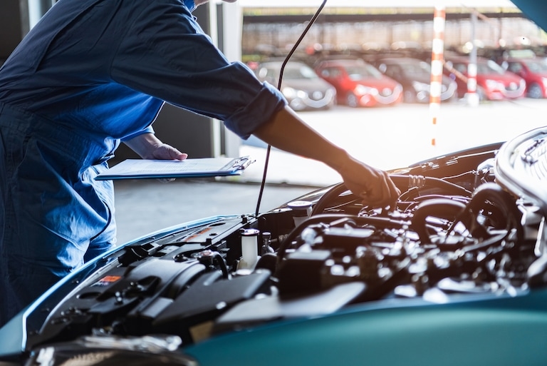 Mechanic working on a vehicle's engine