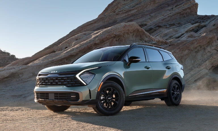 2024 Kia Sportage parked by some rocks