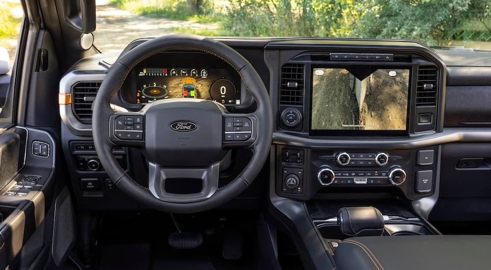 The black interior of a 2024 Ford F-150 Tremor is shown from the driver's seat.